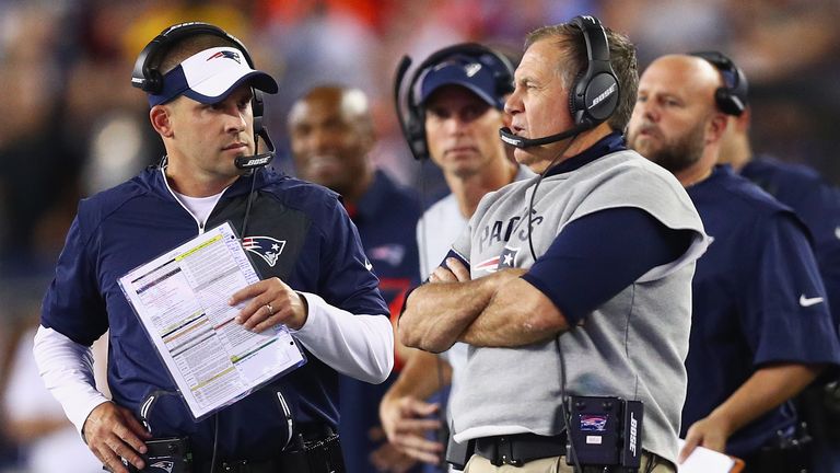 FOXBORO, MA - SEPTEMBER 22:  Head coach Bill Belichick of the New England Patriots (R) talks with offensive coordinator Josh McDaniels during the first hal