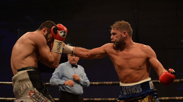 GLASGOW, SCOTLAND - DECEMBER 03: Billy Joe Saunders of England (blue shorts), takes on Artur Akavov of Russia (black shorts),  during the defence of his WB