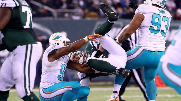 EAST RUTHERFORD, NJ - DECEMBER 17:   Bryce Petty #9 of the New York Jets gets tackled by  Cameron Wake #91 of the Miami Dolphins during the fourth quarter 