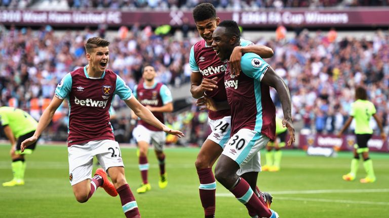 LONDON, ENGLAND - AUGUST 21:  Michail Antonio (#30) of West Ham United celebrates scoring the opening goal with team mates Ashley Fletcher and Sam Byram (L