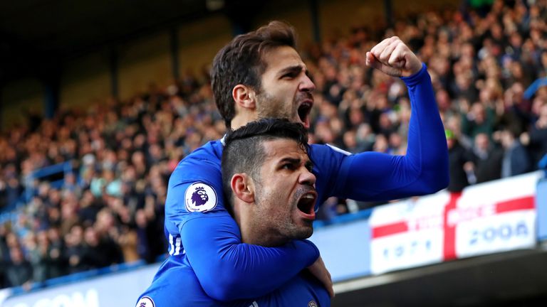 LONDON, ENGLAND - DECEMBER 11:  Diego Costa (bottom) of Chelsea celebrates scoring the opening goal with his team mate Cesc Fabregas (top) during the Premi