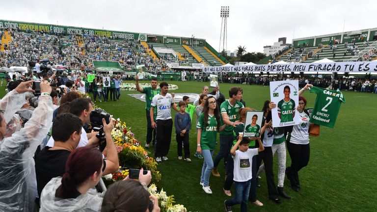 Relatives of the members of the Chapecoense Real football club team killed in a plane crash in Colombia enter the field during a funeral ceremony at the st