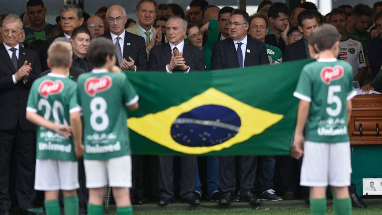 Brazil's President Michel Temer (C) attends the funeral of the members of the Chapecoense Real football club team killed in a plane crash in Colombia, at t