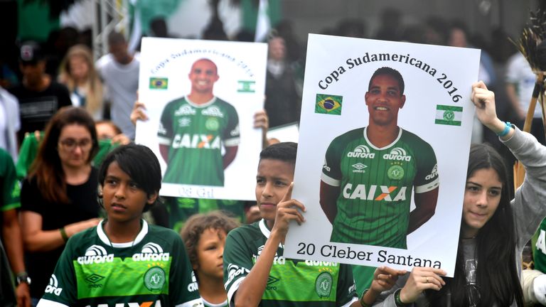 Relatives of the members of the Chapecoense Real football club team killed in a plane crash in Colombia enter the field during a funeral ceremony at the st