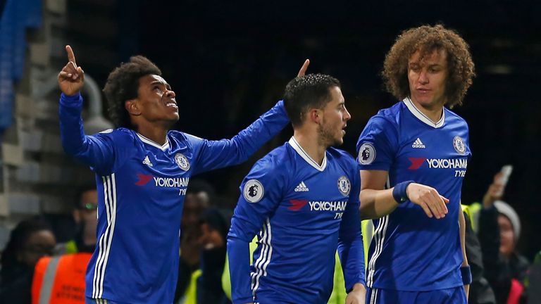 Chelsea's Brazilian midfielder Willian (L) celebrates with teammates after scoring their second goal during the English Premier League football match betwe