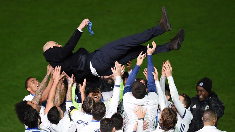 Zinedine Zidane is thrown into the air by Real Madrid players after winning the Club World Cup