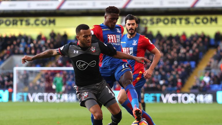 LONDON, ENGLAND - DECEMBER 03: Ryan Bertrand of Southampton and Wilfried Zaha of Crystal Palace compete for the ball during the Premier League match betwee