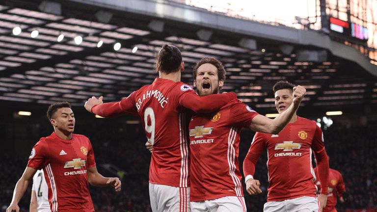 Manchester United's Dutch midfielder Daley Blind (CR) celebrates scoring the opening goal during the English Premier League football match between Manchest