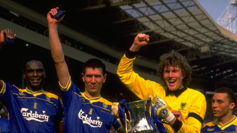 May 1988:  (From left to right) Eric Young, Lawrie Sanchez, Dave Beasant and Terry Phelan of Wimbledon celebrate with the trophy after their victory in the