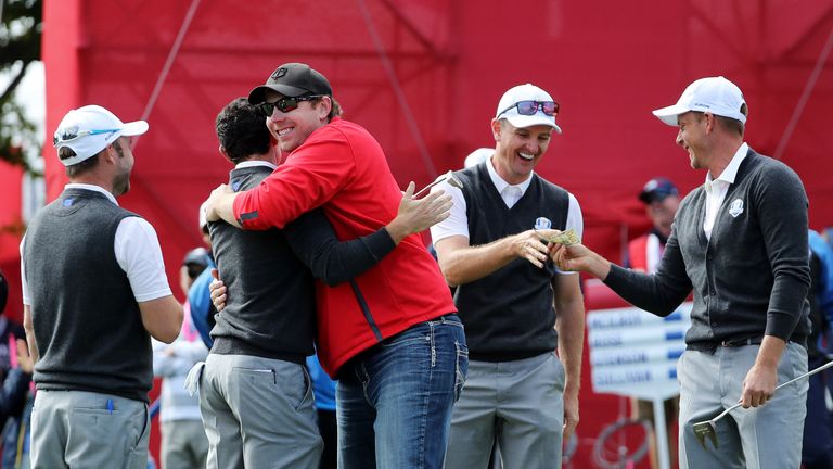 CHASKA, MN - SEPTEMBER 29:  Fan David Johnson of North Dakota hugs Rory McIlroy of Europe after being pulled from the crowd and making a putt on the eighth