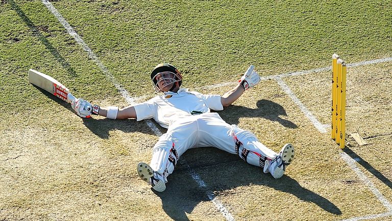 David Warner of Australia lies on the pitch after slipping while playing a shot