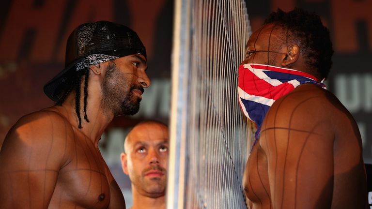 LONDON, ENGLAND - JULY 12:  David Haye (left) and Dereck Chisora eyeball each other as Haye's trainer Adam Booth (centre) looks on during the Weigh-In at T