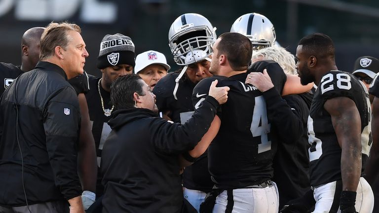 OAKLAND, CA - DECEMBER 24:  Derek Carr #4 of the Oakland Raiders is helped off the field after injuring his right leg during their NFL game against the Ind
