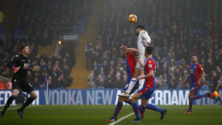 Chelsea's Brazilian-born Spanish striker Diego Costa (C) jumps to head the ball and score his team's first goal during the English Premier League football 