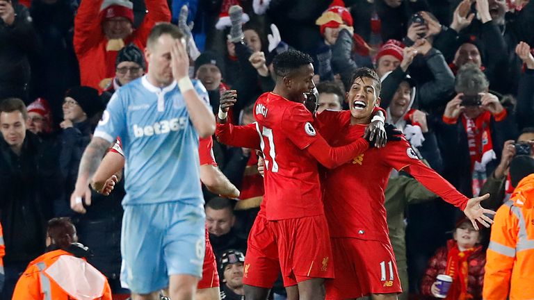 Liverpool's Divock Origi (centre) and Roberto Firmino (right) celebrate their third goal of the game during the Premier League match v Stoke at Anfield