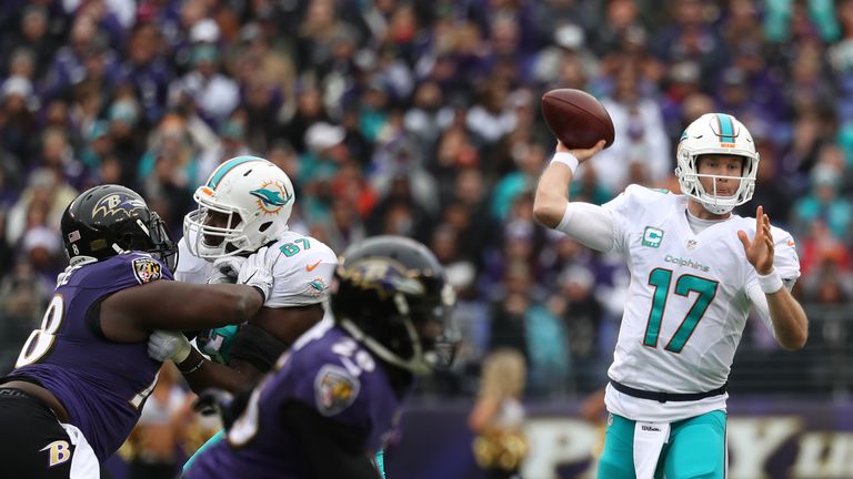 BALTIMORE, MD - DECEMBER 4: Quarterback Ryan Tannehill #17 of the Miami Dolphins passes the ball while teammate offensive guard Laremy Tunsil #67 blocks ag