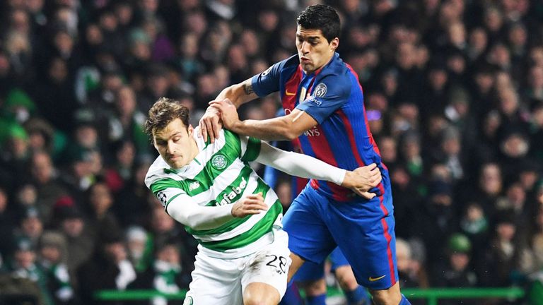 Celtic defender Erik Sviatchenko holds off a challenge from Barcelona's Luis Suarez