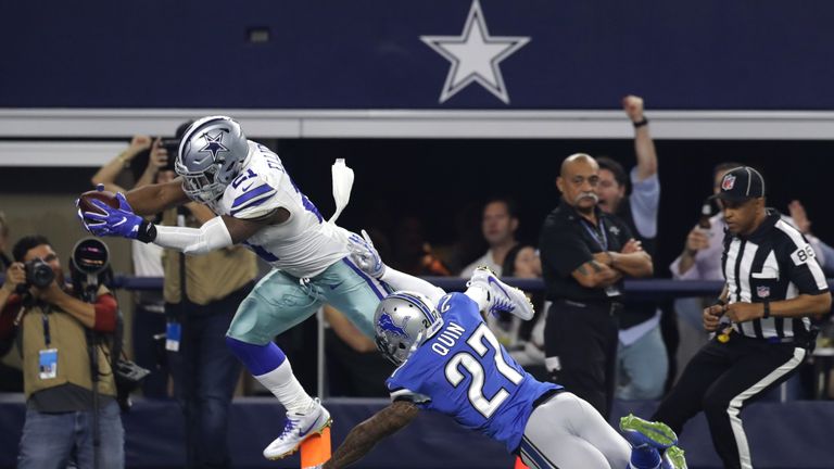 ARLINGTON, TX - DECEMBER 26: Ezekiel Elliott #21 of the Dallas Cowboys dives across the goal line to score a touchdown as Glover Quin #27 of the Detroit Li