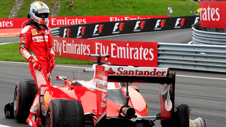 Sebastian Vettel examines his punctured Ferrari car at the Austrian GP - Picture from Sutton Images 