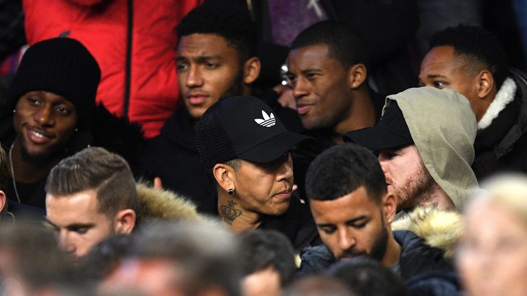 Players including Roberto Firmino, Georginio Wijnaldum, Alberto Moreno and Nathaniel Clyne watch on.