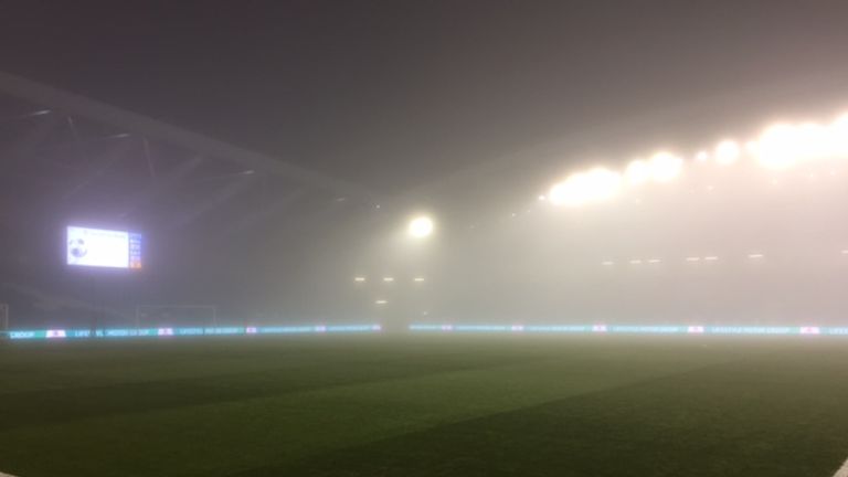 Floodlights glisten through the fog at Brighton