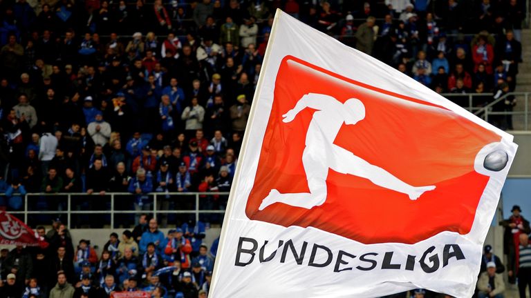 Fans wave a giant flag baring the Bundesliga logo