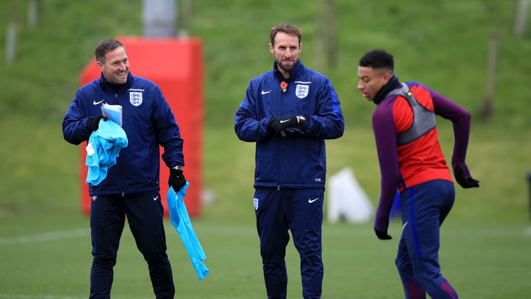 England manager Gareth Southgate (centre) and assistant Steve Holland (left) watch Jesse Lingard (right) during a training session at St George's Park