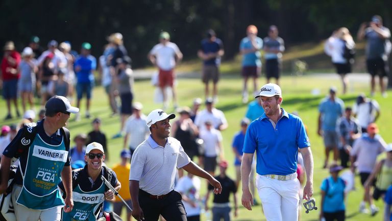 Harold Varner III of the US (C) and Andrew Dodt of Australia (R) smile during the final round of the Australian PGA Championship at Royal Pines, Gold Coast