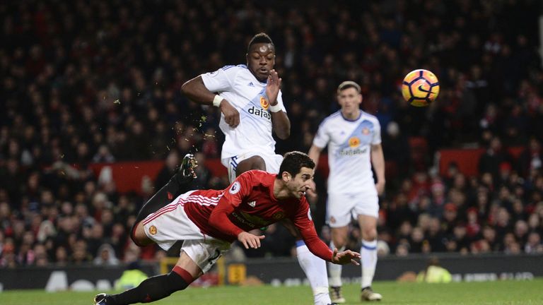 Manchester United's Armenian midfielder Henrikh Mkhitaryan (C) strikes the ball with the back of his heel to score their third goal during the English Prem