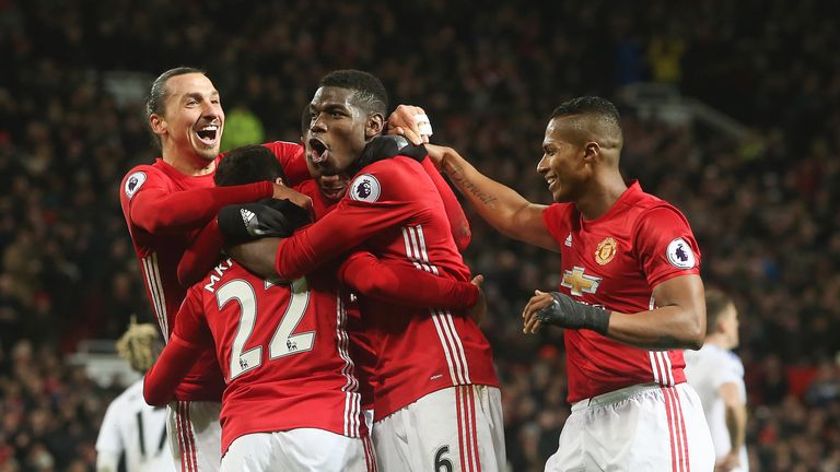 Manchester United players surround Henrikh Mkhitaryan after his strike extends their lead to 3-0