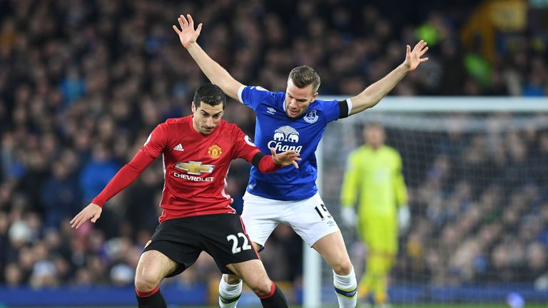 Henrikh Mkhitaryan (L) vies with Everton's English midfielder Tom Cleverley during the Premier League footballer
