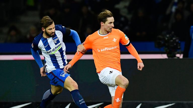 Hertha Berlin's defender Marvin Plattenhardt (L) fouls Darmstadt's defender Sandro Sirigu during the German first division Bundesliga football match Hertha