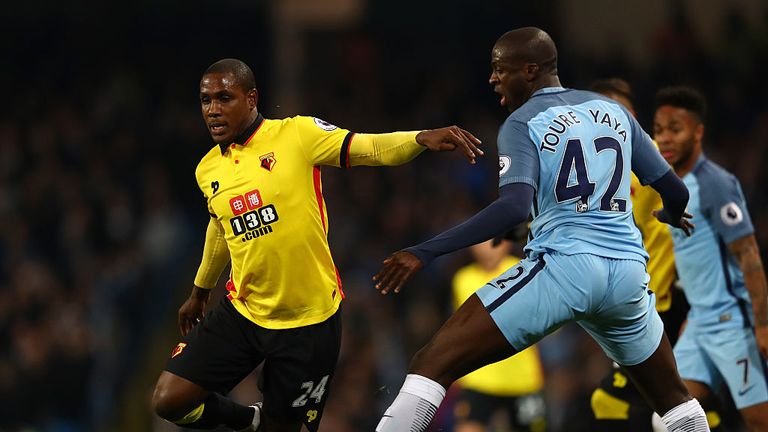  Odion Ighalo of Watford and Yaya Toure of Manchester City compete for the ball