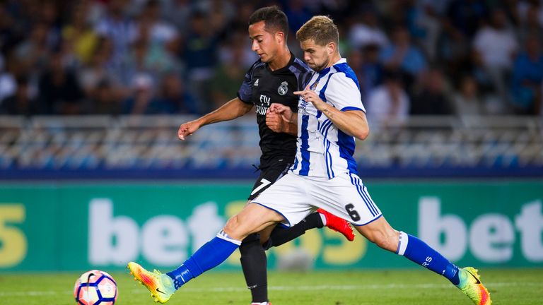 Real Sociedad's Inigo Martinez tackles Lucas Vazquez of Real Madrid