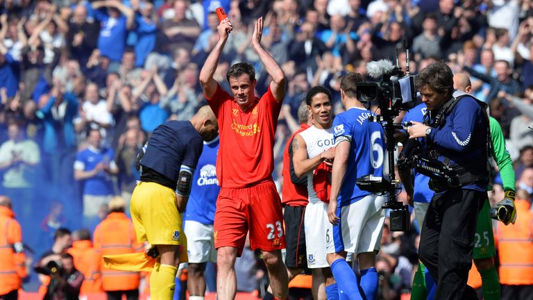 Liverpool's English defender Jamie Carragher (L) applauds the crowd after his final derby match before retiring after the English Premier League football m