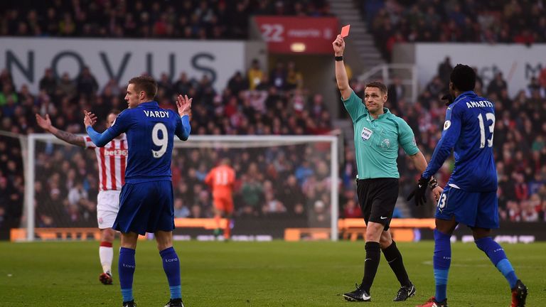 English referee Craig Pawson (C) shows a red card to Leicester City's English striker Jamie Vardy (2L) 