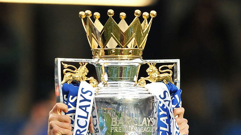 Chelsea's English midfielder Joe Cole celebrates with the Barclays Premier league trophy after Chelsea win the title with a 8-0 victory over Wigan Athletic