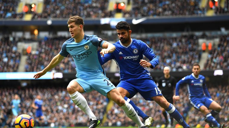 MANCHESTER, ENGLAND - DECEMBER 03:  John Stones of Manchester City controls the ball under pressure of Diego Costa of Chelsea during the Premier League mat