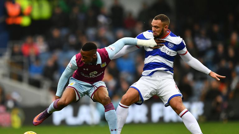 Jonathan Kodjia of Aston Villa holds off Joel Lynch of Queens Park Rangers