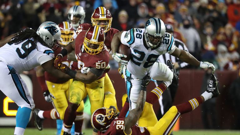 LANDOVER, MD - DECEMBER 19: Running back Jonathan Stewart #28 of the Carolina Panthers carries the ball against running back Keith Marshall #39 of the Wash