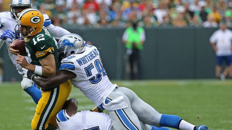 GREEN BAY, WI - SEPTEMBER 25:  Aaron Rodgers #12 of the Green Bay Packers is stopped short of a first down by Brandon Copeland #51 and Tahir Whitehead #59 