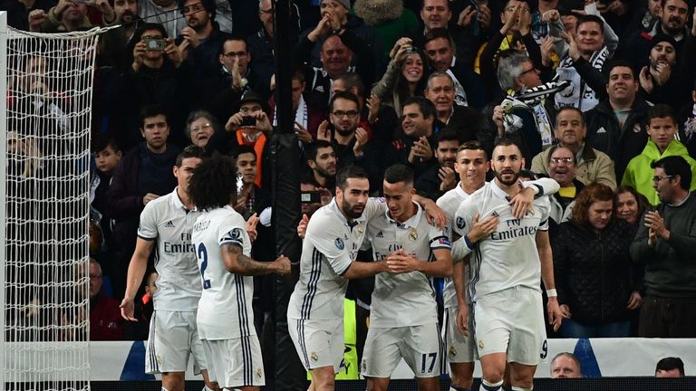 Real Madrid's French forward Karim Benzema (R) celebrates with teammates after scoring a goal during the UEFA Champions League football match Real Madrid C