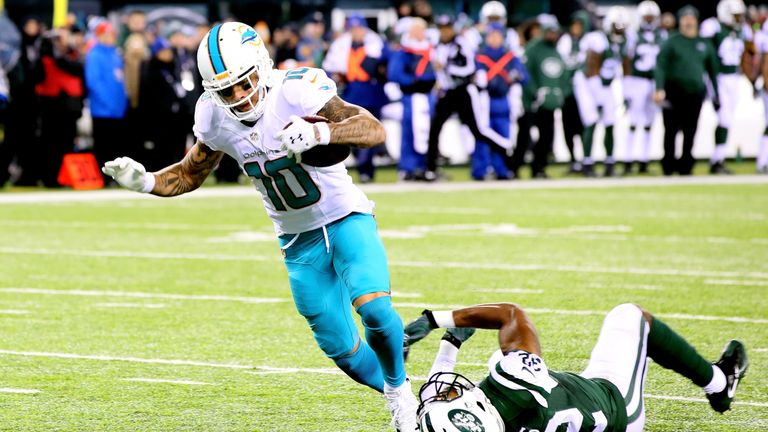 EAST RUTHERFORD, NJ - DECEMBER 17:  Kenny Stills #10 of the Miami Dolphins scores a 52 yard touchdown against Juston Burris #32 of the New York Jets during