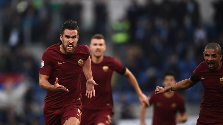 Roma's midfielder from Netherlands Kevin Strootman (L) celebrates after scoring during the Italian Serie A football match SS Lazio vs AS Roma on December 4