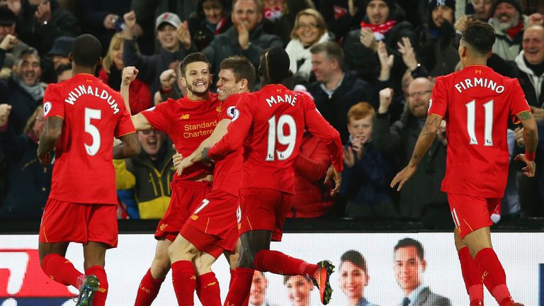 LIVERPOOL, ENGLAND - DECEMBER 11:  Adam Lallana (2nd L) of Liverpool celebrates scoring the opening goal with his team mates during the Premier League matc