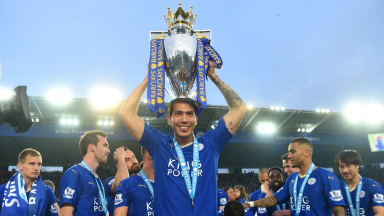LEICESTER, ENGLAND - MAY 07:  Leonardo Ulloa of Leicester City lifts the Premier League Trophy as players and staffs celebrate the season champion after th