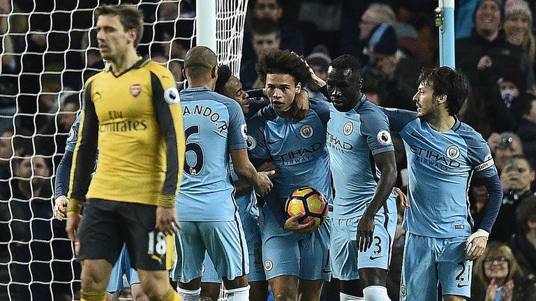 Leroy Sane (C) celebrates with his team-mates after equalising for Man City against Arsenal
