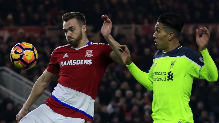 Middlesbrough defender Calum Chambers (L) vies with Liverpool midfielder Roberto Firmino 