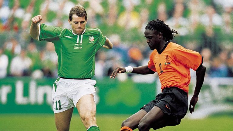 Mario Melchiot of Holland is closed down by Kevin Kilbane of the Republic of Ireland during a World Cup Qualifier at Lansdowne Road