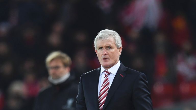 Jurgen Klopp and Mark Hughes stand on the touchline at Anfield